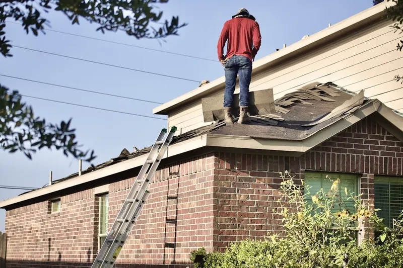 Professional roofer working on a residential roof in Robinson